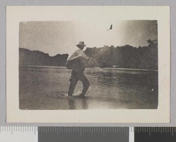 Two men crossing water