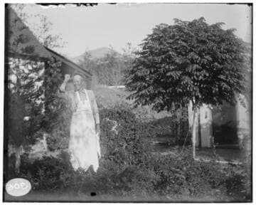 A man standing outside of an residence