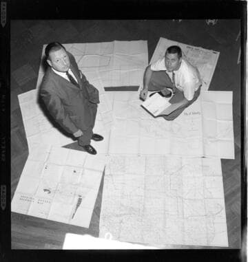 Men reviewing Official Zoning District Maps
