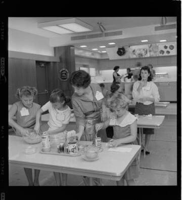 Young girls cooking in an all electric teaching kitchen