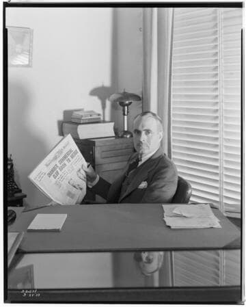Manager/editor of Huntington Park Signal at his desk with front page of newspaper