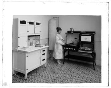 Hughes range and water heater in studio kitchen with two women cooking