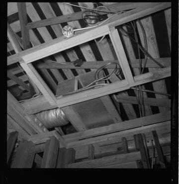 Central air conditioning being installed at home construction site during the framing stage