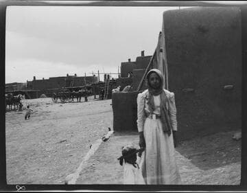 A young woman and child in Taos Pueblo