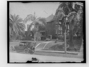 View of house on a residential street and car parked in front