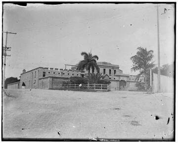 Fort-like building with "1857" painted above the front door