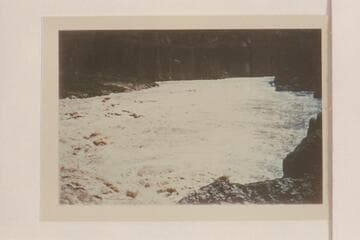 Inboard motorboat pulling clear of rough water of Vulcan Rapid