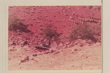 The "Rattlesnake" in Hance Rapid.  Rod Sanderson is piloting, John Doerr sits starboard, Joe Desloge is center and Hugh Cutler is right