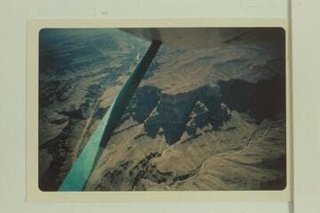 Irvin [sic] Butte at center.  The sun shines on the flow of water below the spring at the foot of the butte