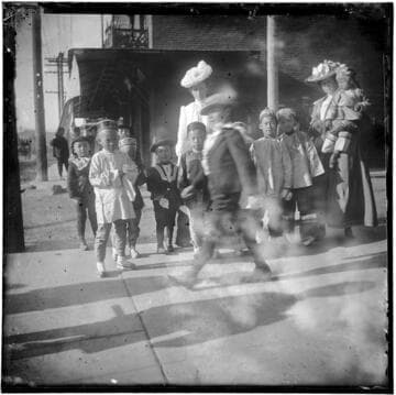 Group of Chinese children outside with two women