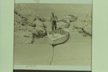 The Nevills sadirons at left bank part way down Sockdologer Rapid.  Caption on reverse reads:  First time boats ever made a stop in the middle of the famous Sockdologer Rapid.  Ate lunch here!
