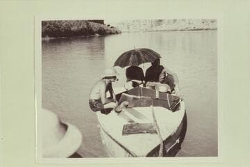 In Glen Canyon near Warm Creek.  The boats were being towed by an outboard motor on the Wen.  Nevills 1940 party.  Del Reed sits at left