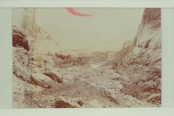 Hole in the Rock.  The men were likely part of the crew in the previous picture showing the Hole in the Rock from below.  From Stanton collection