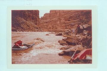 Jorgen Visbak holds his Yak while Dock Marston slides his thru the rocks at Dark Canyon Rapid