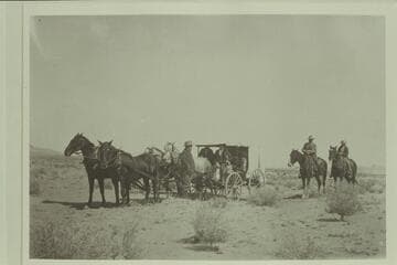 White-topped buggy owned by Charles Gibbons, Hanksville, Utah, and used for meeting guests in Green River.  Left to right:  Cunningham; Rufus Stoddard; Weisholn; Charles Gibbons on "Old Betsey," George Gould