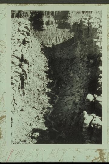Northerly down the graben that drains into Red Lake Canyon about a mile from the Colorado River.  The small pinnacle at the right side of the mouth shows in Reilly photo #3 internegative 584 CTCN 213.3 and in Marston photo 5610 CTCN 213.4