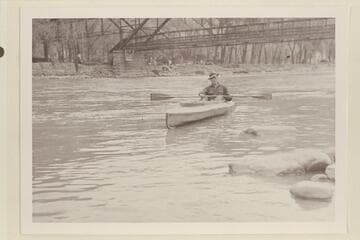 Harold H. Leich in his folding kayak "Rob Roy".  Leaving Glenwood Springs after staying the weekend in Glenwood Hotel. Leich left the following Monday at 10:30 am and passed under the railroad bridge.  He had started from Grand Lake July 21, 1933