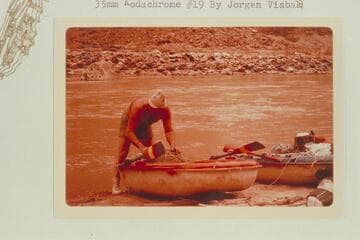 Bill Belknap finishing the packing of the Sportyak.  Camp at Mile 204.9 opposite the mouth of Range Canyon