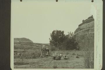 Camp on the Dolores River below Gateway.  Sheep camp.  [on reverse:  "Washing dishes at the sheep camp"]