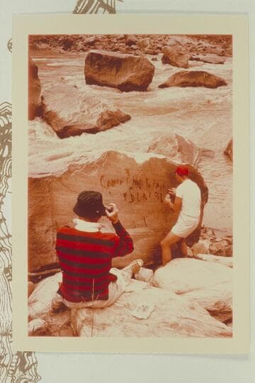 Dock photographs Jorgen Visbak wetting the Best Expedition inscription reading. "Camp No. 7.  Hell To Pay.  No. 1 is Sunk and Down"  cut in the rock by McDonald
