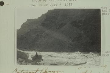 [on photo reverse:  The 60-ft. bent log, for identification.  Rapid #22.  Pictures taken about 9 AM]  Information sent by Davis 9 10 64 locates this as foot of Rapid 22 where he upset near its head and had traveled upside down into eddy below