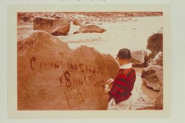 Dock Marston points up the Best Expedition inscription at Rapid 16