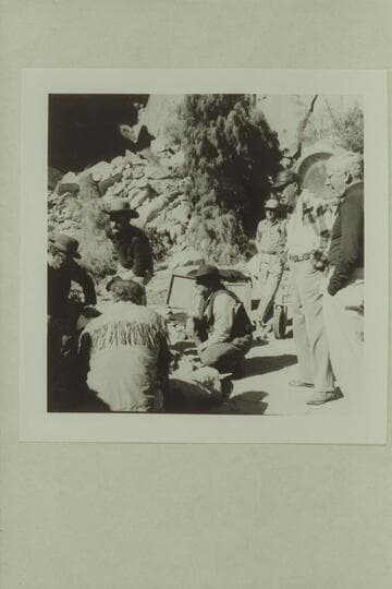 Cast discussing action at camp site below Moab.  "Colorado River Story" filmed by Disney.  Bob Armstrong; Dan Sheridan; Brian Keith; Stan Jones.  Director Bill Beadine and Cameraman Gordon Avil at right