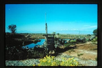 Pond; Henry Mountains from Roost Ranch