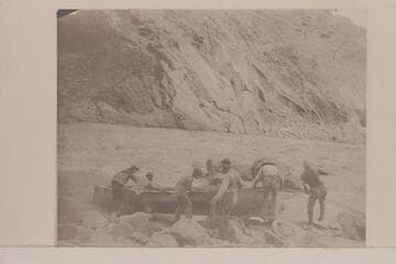 Portage by Stanton crew: "Lifting a Boat over the Head of a Rapid.  Grand Canon."