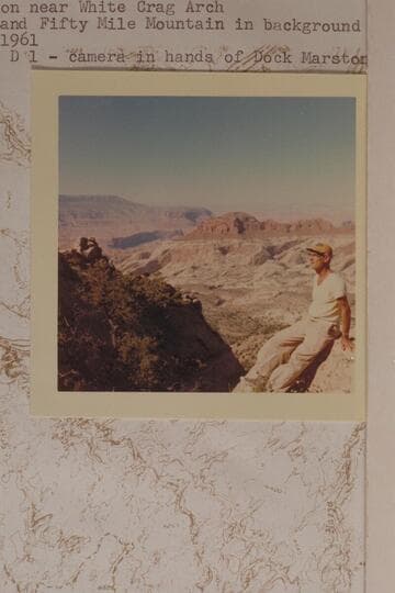 Ballard Atherton near White Crag Arch.  Rainbow Butte and Fifty Mile Mountain in background