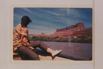 Virginia Hough studies Jackson Hole area at left bank, about Mile 50