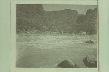 Looking up the Green River at top of Upper Disaster Rapid.  One of the sadiron boats of Reynolds is approaching the head of the rapid
