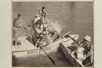Water fight; Lake Mead;left to r: Nevills;Lucile Hiser hidden back of Garth Marston who is throwing bucket of water;Nancy Streator at the oars of the "Wen,"John Doerr getting the ducking;Moulty Fulmer almost hidden by the spray;Marston at extreme right