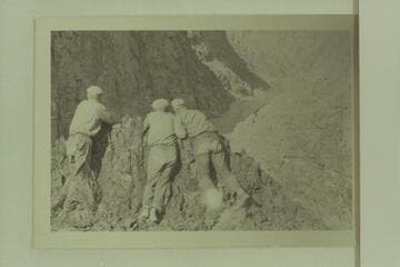 The three boatmen of the Carnegie-Caltech party looking at Lava Cliff Rapid- Spencer, Clark and Dodge