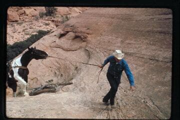 Bill Belknap leads his horse out of Nasja Creek