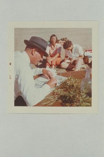 The Flying Bishop Bill Wells makes out the wedding papers while Nina Robison records notes for her news item.  For some reason the bride does not look happy.  The Chapel, Glen Canyon, Mile 118.5
