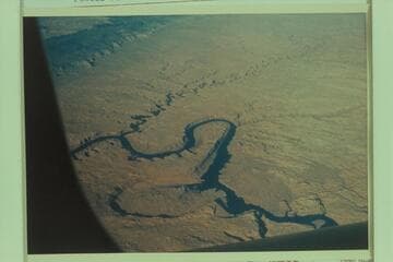 Down Glen Canyon from over Wilson Canyon at Mile 101.  The Rincon is lower left.  The Kaiparowits is upper left and the Escalante River crosses upper from right to left.  Powell Puddle is partially filled