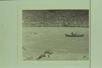 One of the Caltech boats and Buzz Holmstrom in his skiff below Diamond Creek Rapid