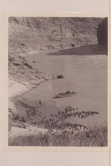 Dock Marston stands near the bow of the "Esmeralda II" above Vaseys Paradise