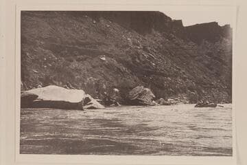 One of the Nevills boats dropping into Paria Riffle.  Old Mormon Dugway on left bank