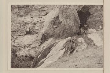The travertine block at the mouth of Travertine Canyon.  Ballard Atherton stands in the hole while Chuck Richey watches the stream from extreme right