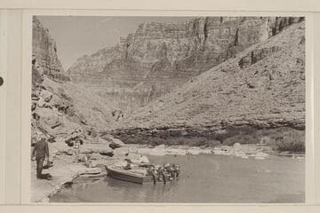 The boats of the 1954 motor traverse in the clear water lagoon at the mouth of the Little Colorado River.  Bill Belknap is at the left of the picture.  Joe Eisaman stands near Hugh Cutler while Joe Desloge sits in the boat