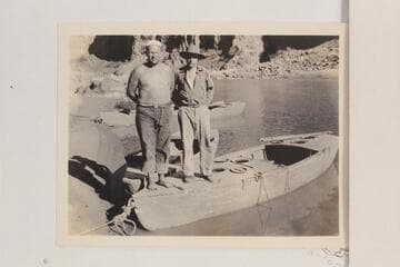 Doc Frazier and Clyde Eddy standing on Frazier's skiff at Pipe Creek