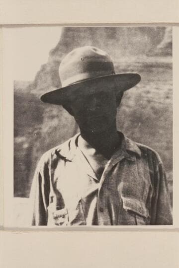 Clyde Eddy (always serious) on right bank of Marble Canyon just above mouth of Little Colorado