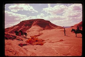 Moving out with stock from the flat-topped butte