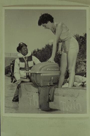 Jimmy Jordan explains the Evinrude motor to Maradel Marston, Paria Riffle