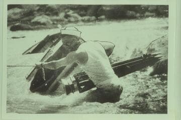 Mace salvages tripod from foundered boat of the Denver Post party during cruise of very low water on the Yampa River