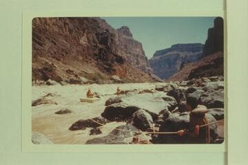 Lining Vulcan Rapid.  Nevills perched on the sadiron; Joe Desloge at center; Garth Marston at lower right