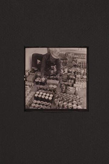 Bill Belknap checks the supplies at Boulder City before taking them to Lees Ferry and other points.  Outboard motor traverse of the Grand Canyon