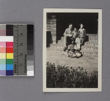 Edwin Powell Hubble and Grace Burke Hubble on their wedding day, Feb. 26, 1924, sitting on the brick steps of the Burke family home, with a dog